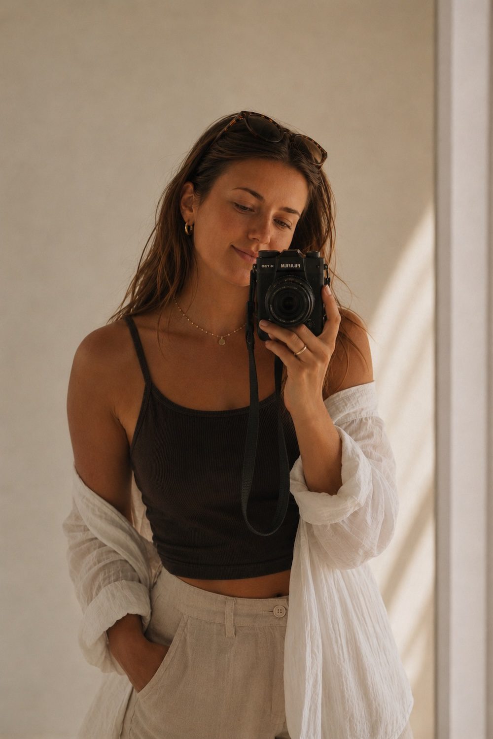 Natalie holding a camera in soft natural light